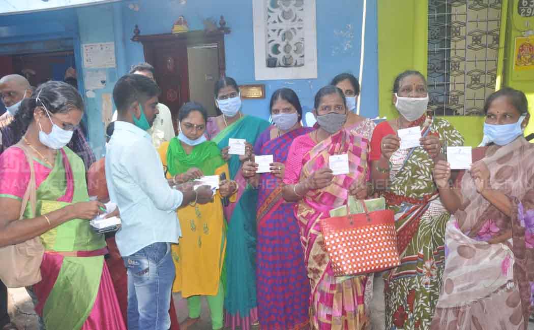 Staff distributing tokens for Pongal gifts