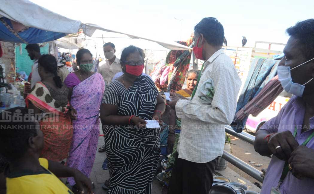Ration shop staff going door to door to give relief tokens