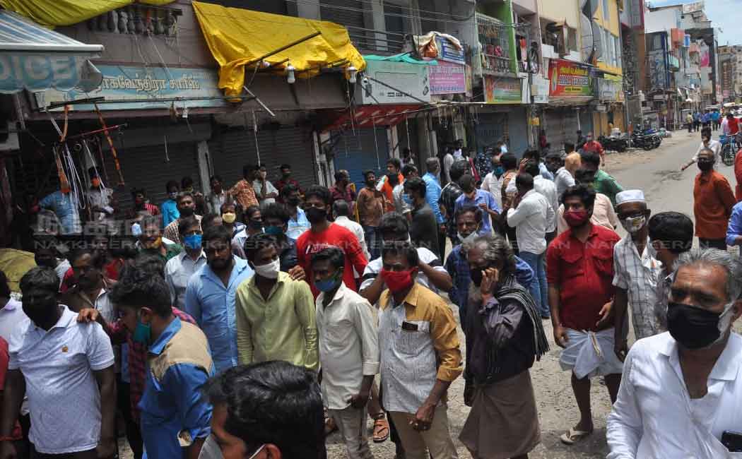 Merchants block the road to open shops