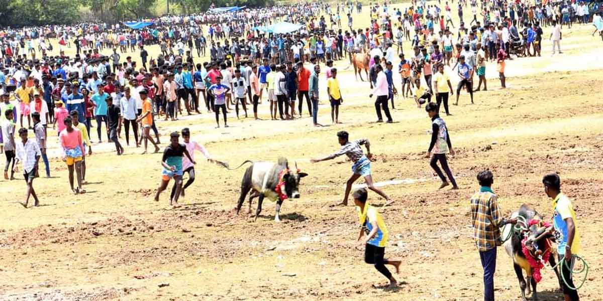 Arulvaku standing on a sickle-people tending to the neighboring village