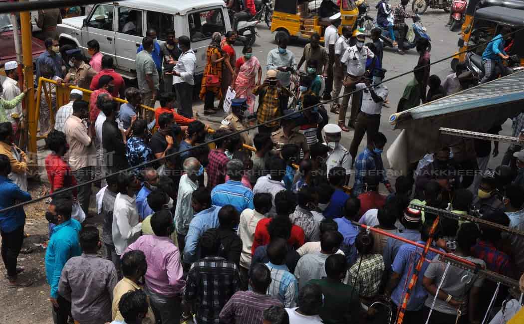 Merchants block the road to open shops