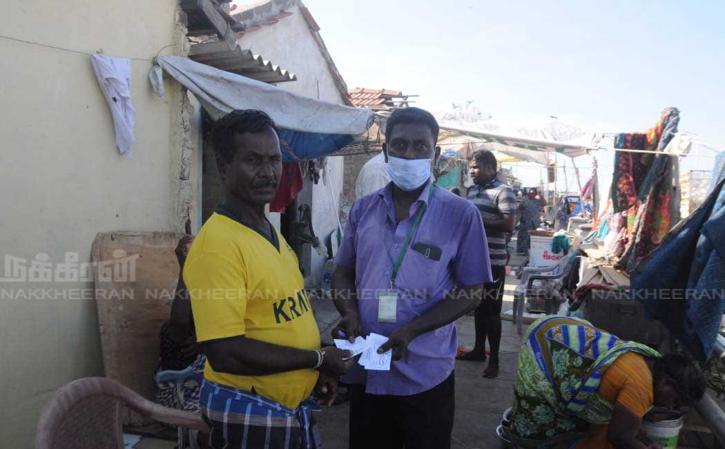 Ration shop staff going door to door to give relief tokens