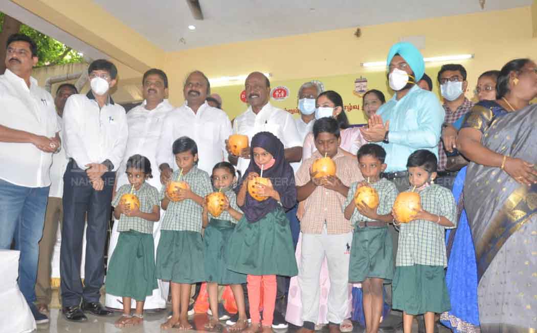 Minister Ma Subramanian giving Elanir to students