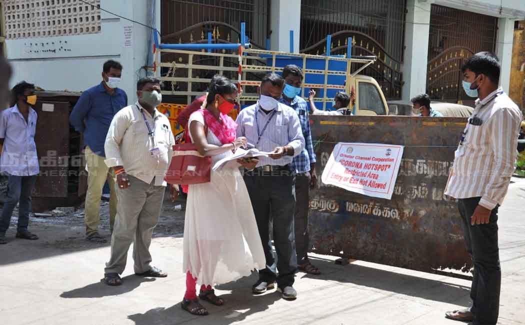 Corporation employees in the process of setting up a barrier