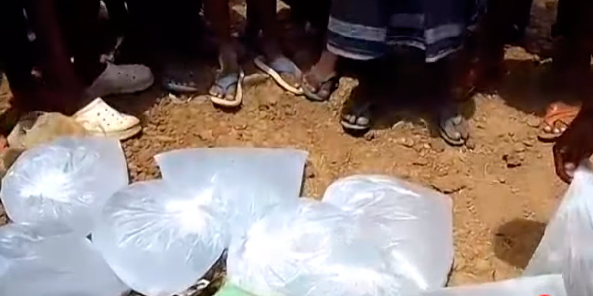 Women struggle by breaking fake liquor packets on the road