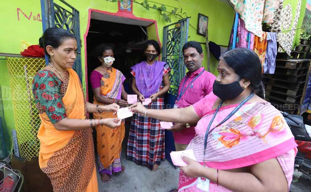 Staff distributing tokens for Pongal gifts