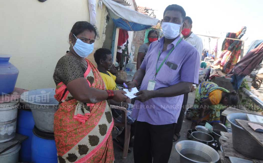Ration shop staff going door to door to give relief tokens