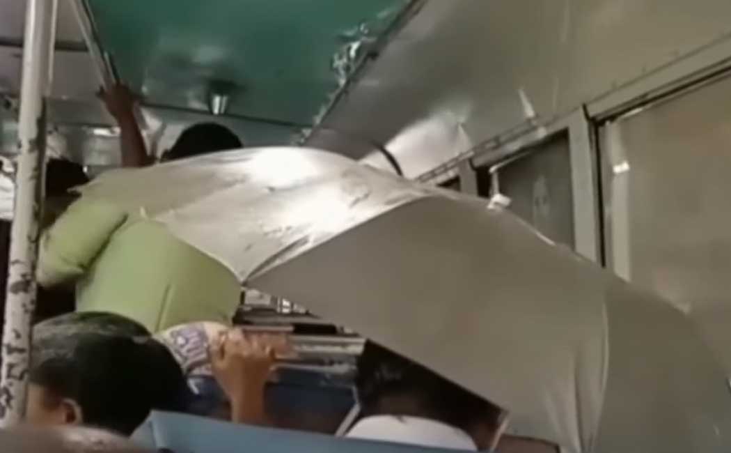 People travel with umbrellas inside the bus!