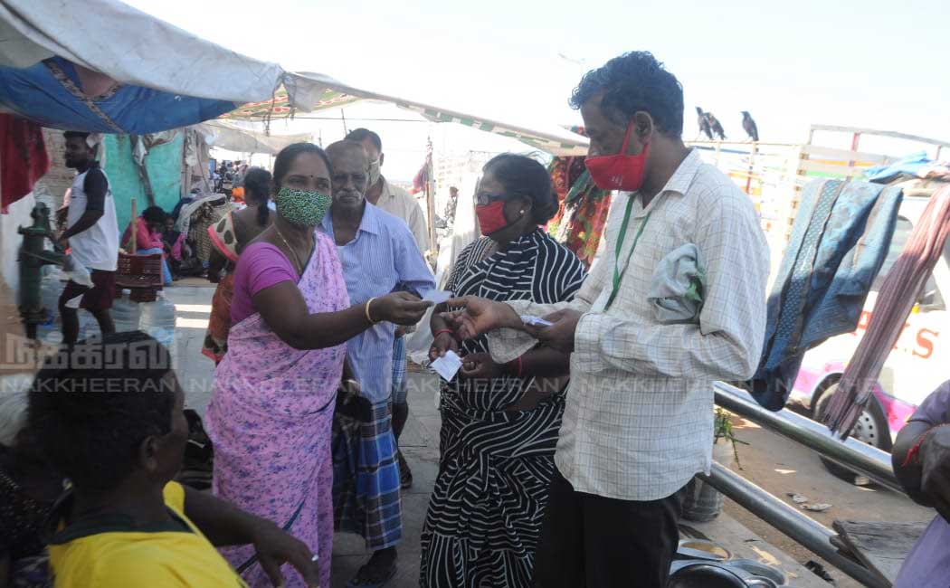 Ration shop staff going door to door to give relief tokens