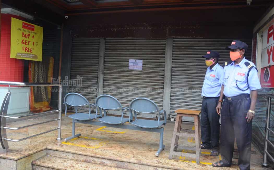 Corporation officials seal the Kumaran Silks shop in Chennai