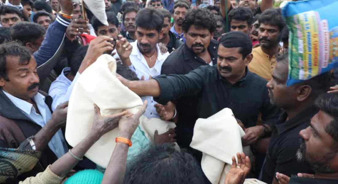 Seaman comforting Nilgiri people affected by rain