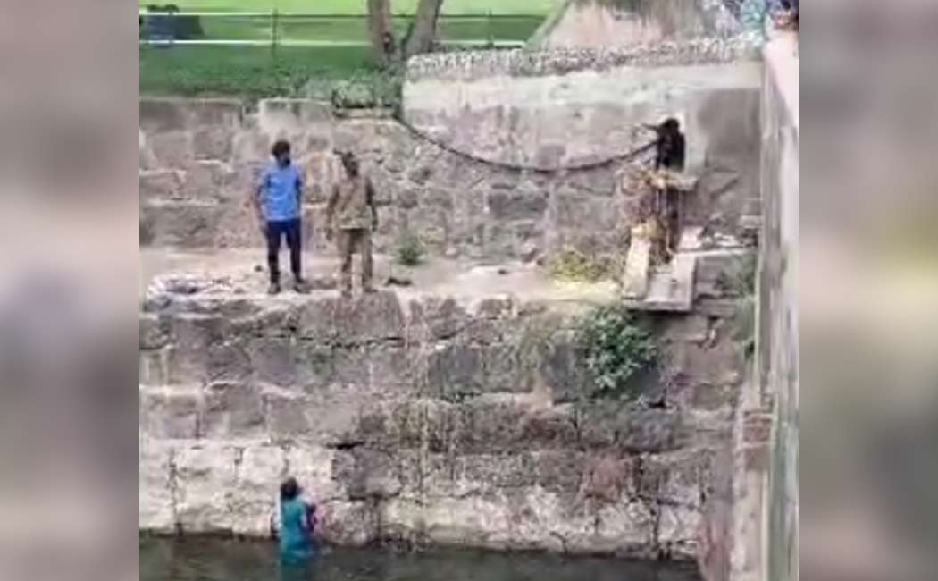 young woman falls into a castle moat