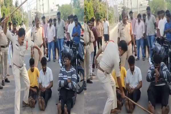 Police beat youths with lathi in the middle of the road in andhra pradesh