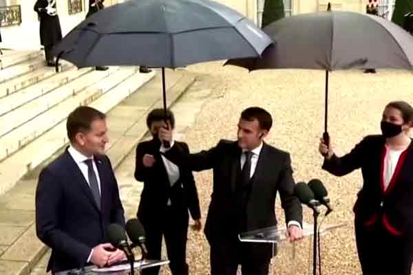 french president holds umbrella for Slovakia prime minister