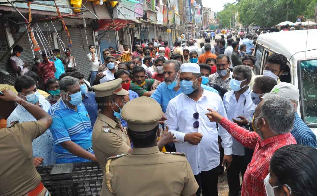 Merchants block the road to open shops
