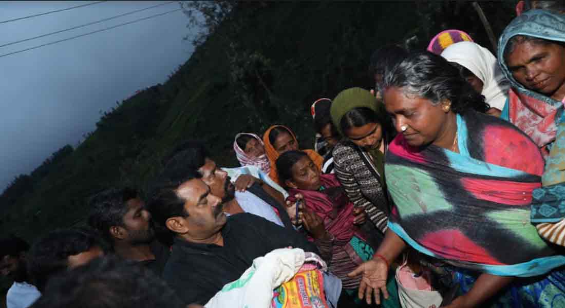 Seaman comforting Nilgiri people affected by rain
