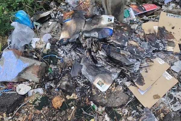 Hundreds of postcards thrown on the road in Kalugumalai