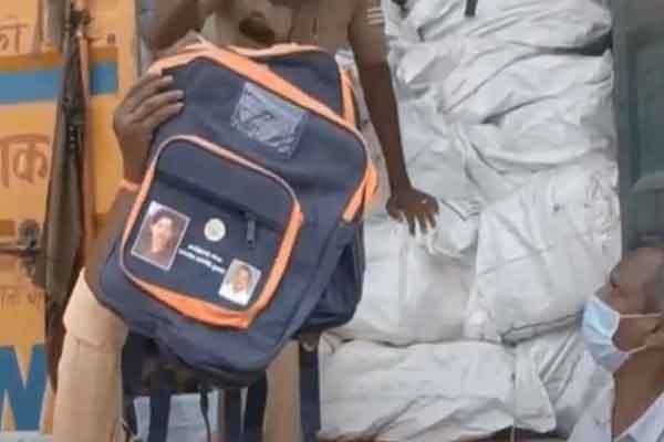 Is there money in the bags with the picture of the Chief Minister? Container