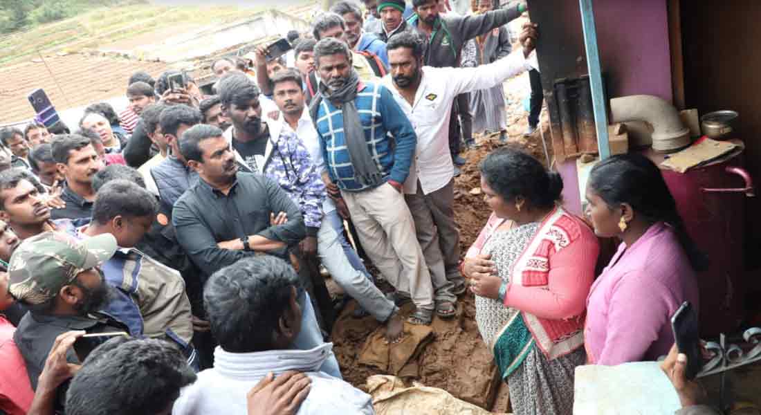 Seaman comforting Nilgiri people affected by rain
