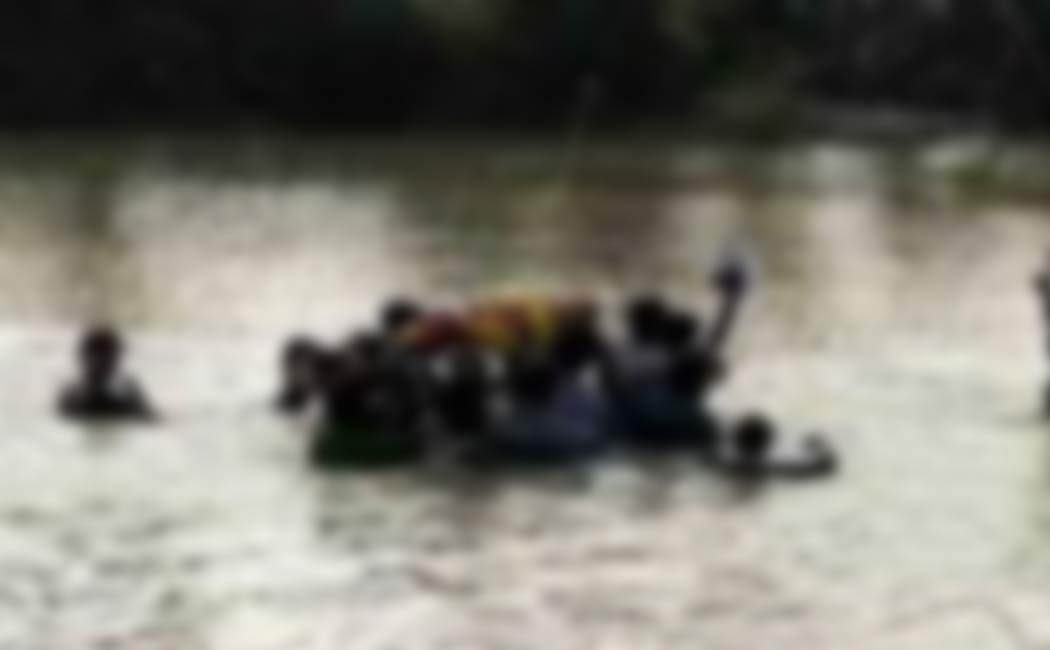 plight carrying body through waist-deep water due lack access cemetery