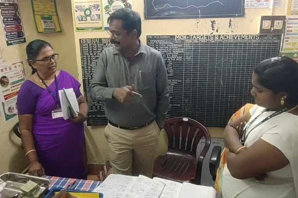 collector sat on the floor and ate the food with the school students