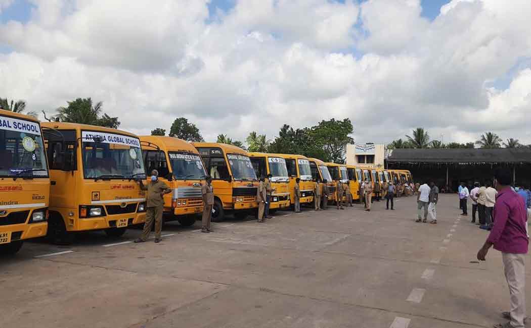 Government officials inspecting school vehicles