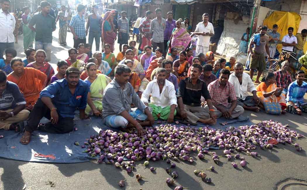 Traders protest by pouring vegetables on the road condemning the change in the vegetable market