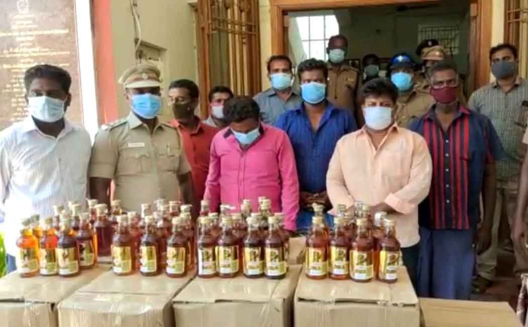 Police arrest people for smuggling liquor on a bike