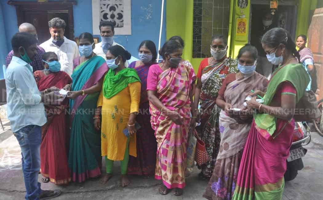Staff distributing tokens for Pongal gifts