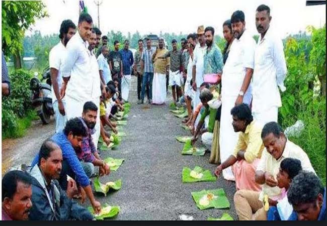 kerala congress party members sitting on the road eating in celebrating the onam festival